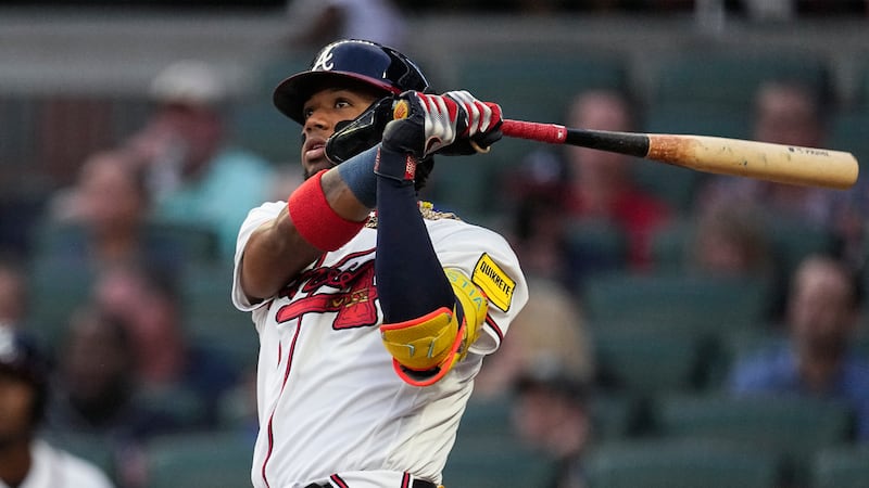 Atlanta Braves' Ronald Acuna Jr. watches his solo home run in the first inning of a baseball...