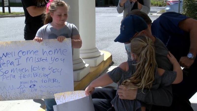 Rob Fennel embraced by his granddaughters