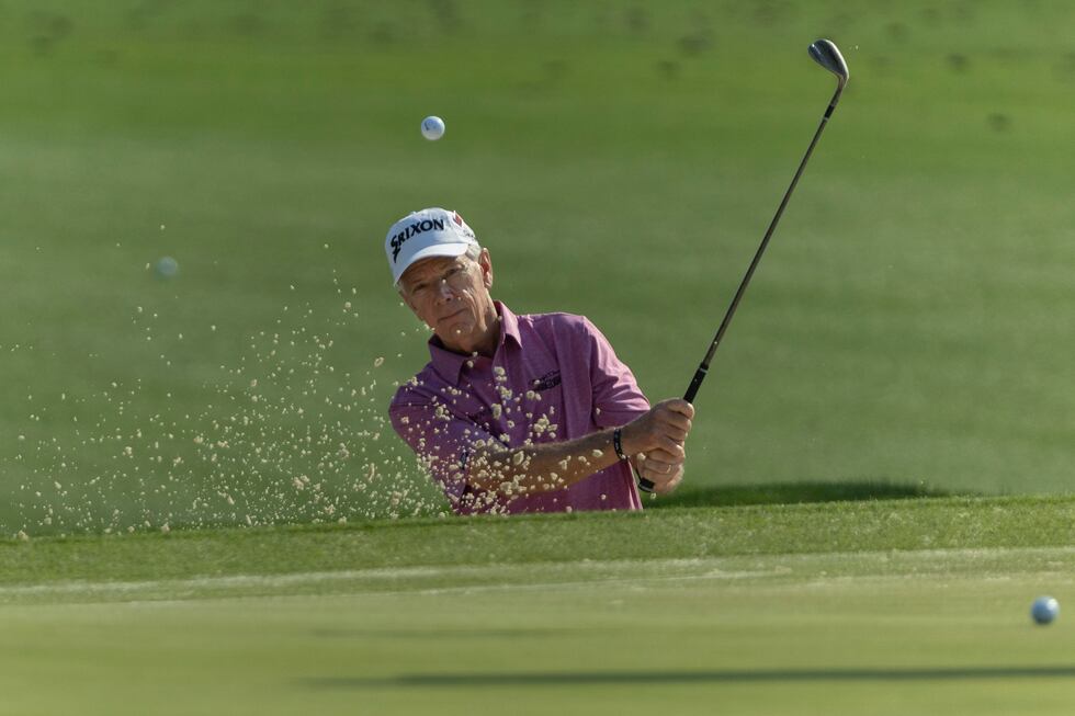 Masters champion Larry Mize of the United States plays out of the bunker on the Tournament...