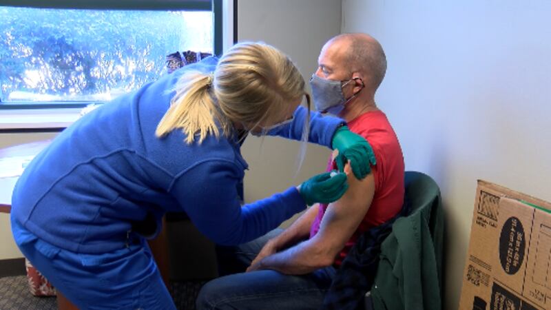 A man receives a COVID-19 vaccine at Friday's clinic put on by Hospice Savannah and Savannah...