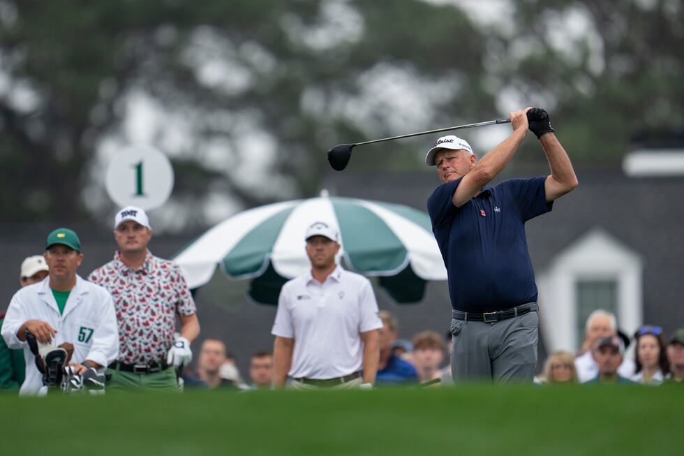 Masters champion Sandy Lyle of Scotland plays a stroke from the No. 1 tee during the first...