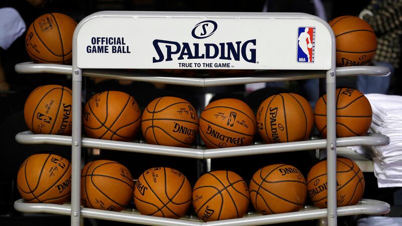 Basketballs sit in a rack on the court during a training session by the Brooklyn Nets at the...