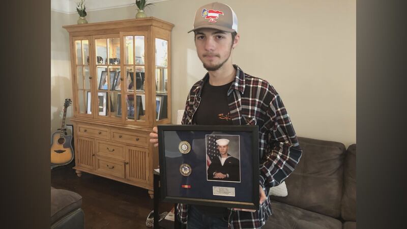 Mason Walters holds a picture of his cousin, 21-year-old Cameron Walters. Walters was one of...