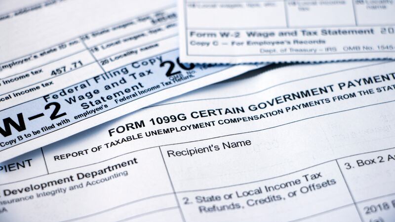 Closeup of overlapping Form 1099G Certain Government Payouts and W-2 forms.