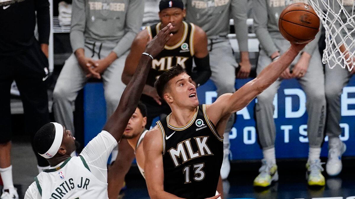 Atlanta Hawks guard Bogdan Bogdanovic (13) shoots next to Milwaukee Bucks center Bobby Portis...